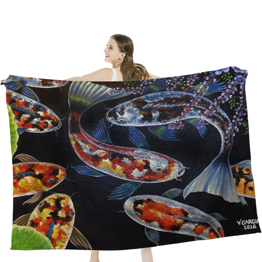 Woman holding a colorful Bangs Garcia Blanket featuring koi fish design, made from soft, hypoallergenic microfiber facecloth.